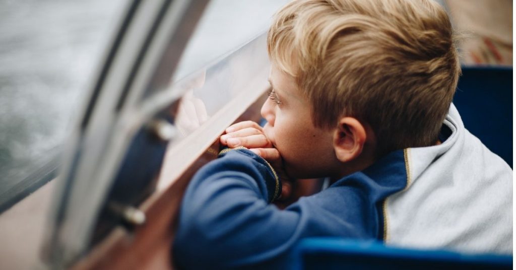 boy gazes out a window